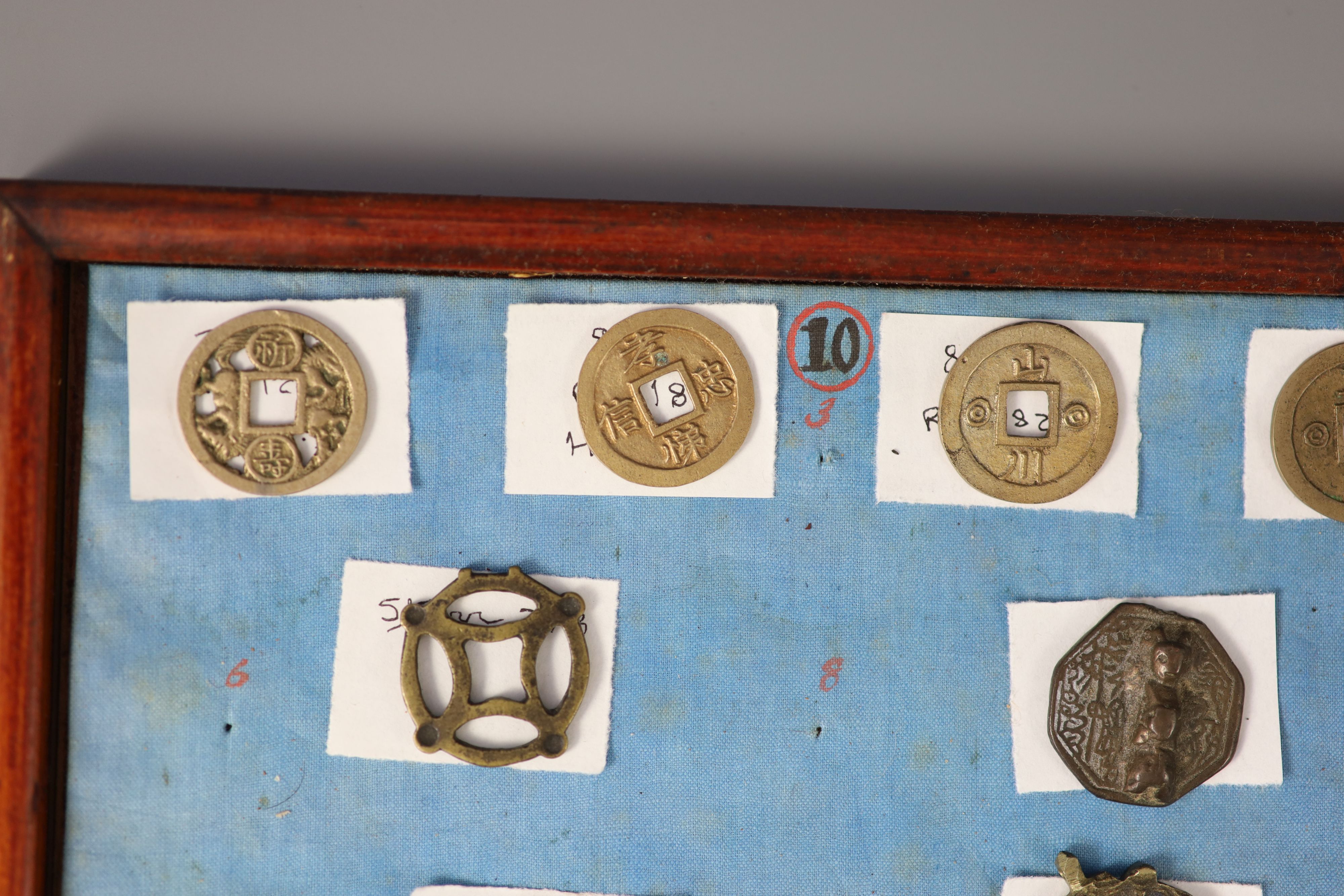 A group of 99 Korean bronze and metal amulets or charms, 19th/20th century